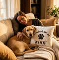 Woman and dog on a couch with a pillow that says 'You had me at WOOF'.